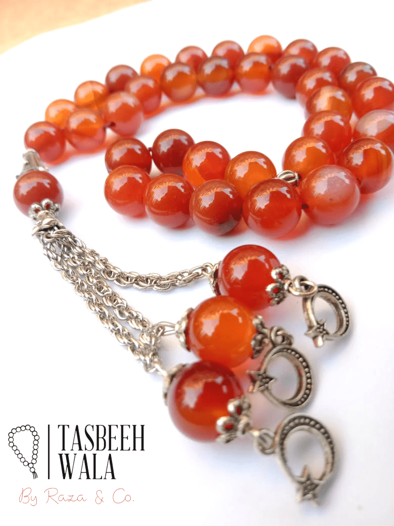 Red Aqeeq Stone Tasbeeh being used for zikr and Islamic prayer